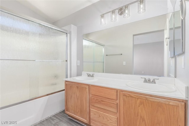 5402 Shady Lair Ct, North Las Vegas, NV 89031 - full bathroom featuring double vanity, shower / bath combination with glass door, and wood finished floors