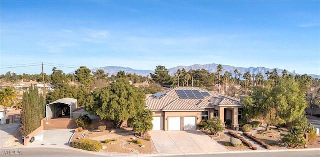 5193 N Miller Ln, Las Vegas, NV 89149 - view of front of house featuring a garage, solar panels, a tile roof, driveway, and stucco siding