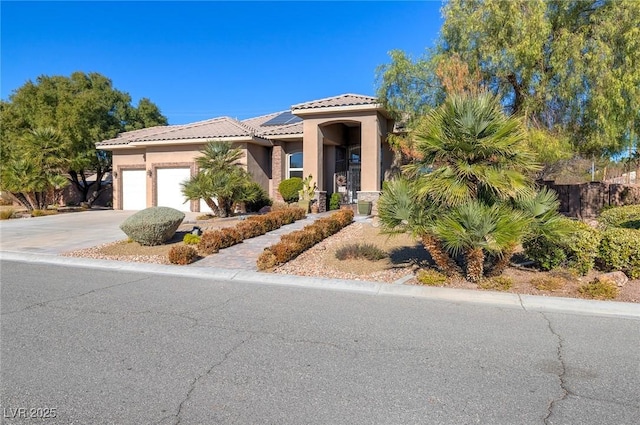 5193 N Miller Ln, Las Vegas, NV 89149 - mediterranean / spanish-style home with a garage, solar panels, a tiled roof, stucco siding, and driveway