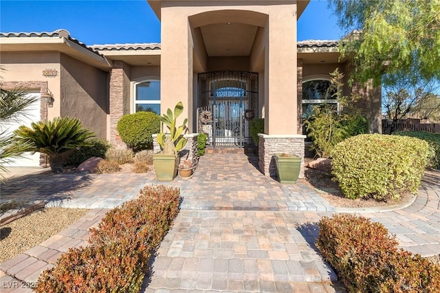5193 N Miller Ln, Las Vegas, NV 89149 - property entrance with a tile roof, french doors, and stucco siding
