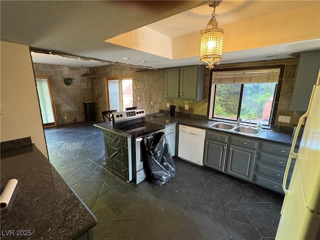 3167 El Cedro Cir, Las Vegas, NV 89121 - kitchen with white appliances, hanging light fixtures, gray cabinets, and a chandelier