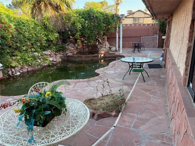 3167 El Cedro Cir, Las Vegas, NV 89121 - fenced backyard with a patio area and a garden pond