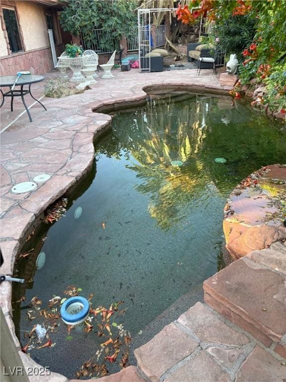 3167 El Cedro Cir, Las Vegas, NV 89121 - swimming pool with a small pond and a patio