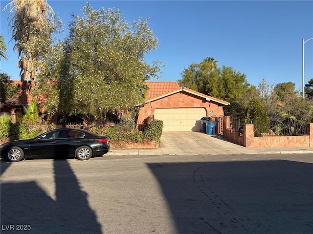 3167 El Cedro Cir, Las Vegas, NV 89121 - view of front of property featuring a garage, concrete driveway, and a tile roof