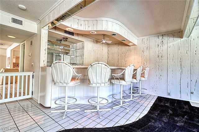 940 Vegas Valley Dr, Las Vegas, NV 89109 - interior space featuring a textured ceiling, wood walls, and ornamental molding