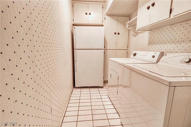 940 Vegas Valley Dr, Las Vegas, NV 89109 - laundry area with washer and dryer, light tile patterned floors, and cabinet space