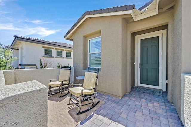 2383 Elmont Ave, North Las Vegas, NV 89086 - entrance to property featuring stucco siding and a patio area