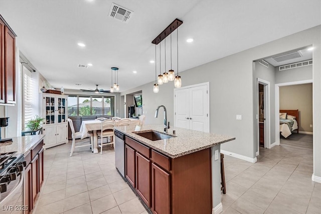 2383 Elmont Ave, North Las Vegas, NV 89086 - kitchen featuring appliances with stainless steel finishes, hanging light fixtures, light stone counters, light tile patterned floors, and recessed lighting