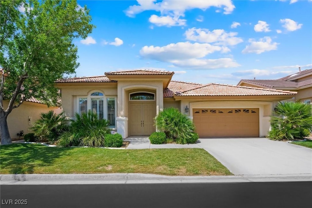 2113 Scarlet Rose Dr, Las Vegas, NV 89134 - mediterranean / spanish-style house featuring an attached garage, stucco siding, a tile roof, and driveway