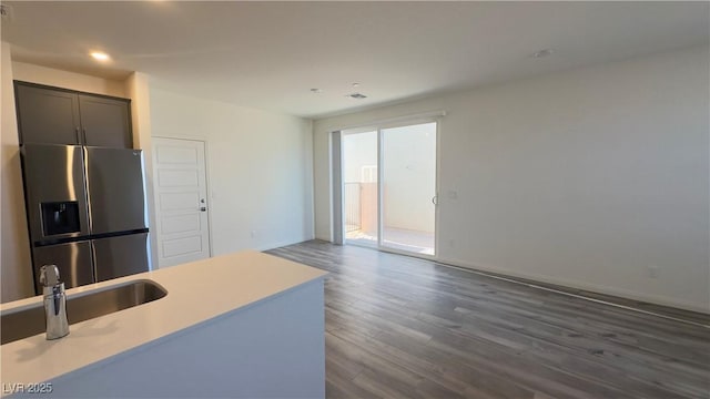 2713 Abrantes Pl, Henderson, NV 89044 - kitchen with stainless steel refrigerator with ice dispenser, light countertops, dark wood-type flooring, recessed lighting, and open floor plan