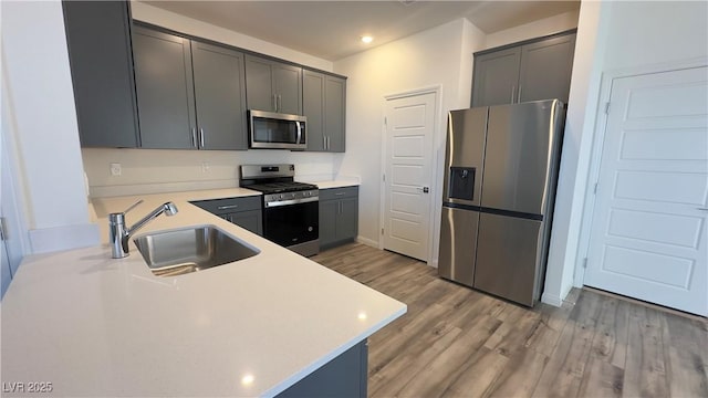2713 Abrantes Pl, Henderson, NV 89044 - kitchen with appliances with stainless steel finishes, light countertops, light wood-style flooring, and recessed lighting