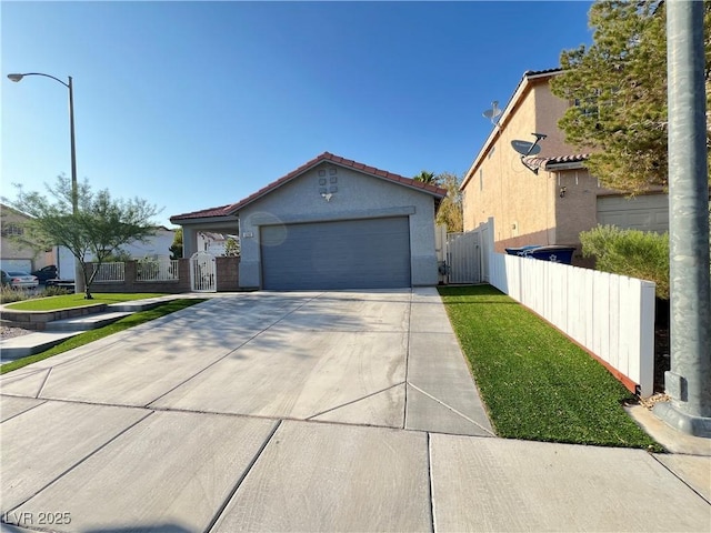 6292 Yucca Valley Ct, Las Vegas, NV 89142 - view of front facade with a gate, stucco siding, a tile roof, concrete driveway, and a garage