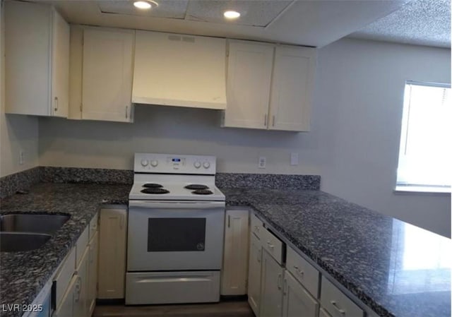 4451 Rich Dr Unit D, Las Vegas, NV 89102 - kitchen with electric range, white cabinetry, healthy amount of natural light, dark wood finished floors, and recessed lighting