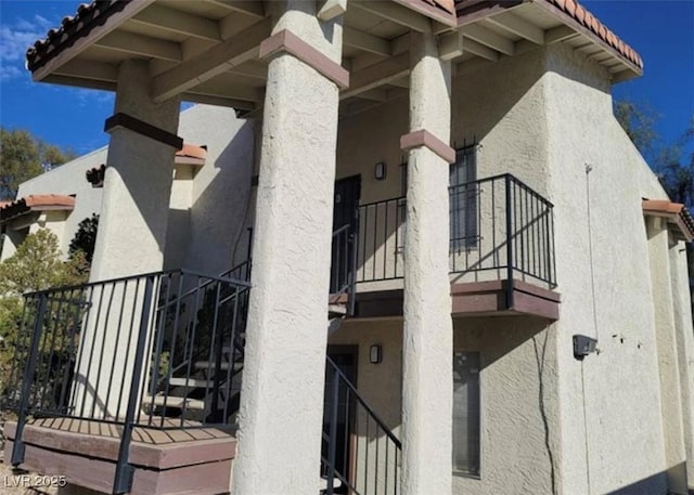 4451 Rich Dr Unit D, Las Vegas, NV 89102 - view of side of property with a balcony, stucco siding, and a tile roof