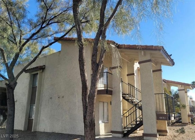4451 Rich Dr Unit D, Las Vegas, NV 89102 - view of side of home featuring stairs and stucco siding
