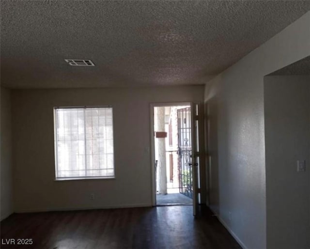 4451 Rich Dr Unit D, Las Vegas, NV 89102 - spare room featuring a textured ceiling and dark wood-style floors