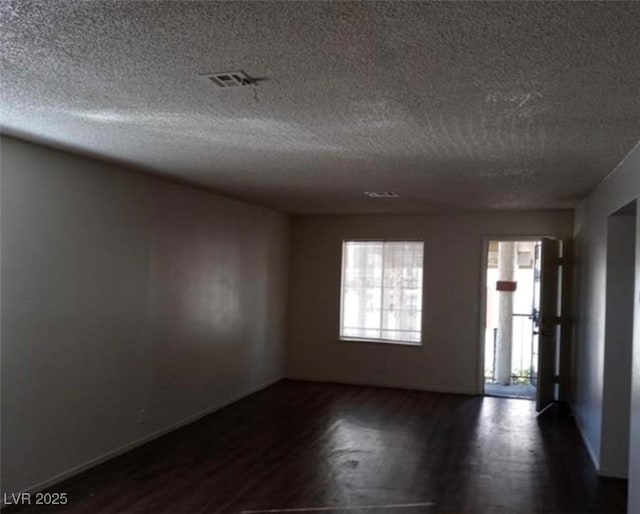 4451 Rich Dr Unit D, Las Vegas, NV 89102 - unfurnished room with dark wood-style floors and a textured ceiling