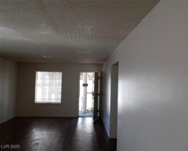 4451 Rich Dr Unit D, Las Vegas, NV 89102 - empty room with a textured ceiling and dark wood-style flooring