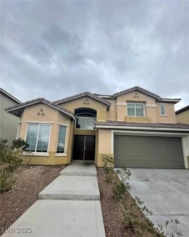 3237 Perching Bird Ln, North Las Vegas, NV 89084 - view of front of property with an attached garage, concrete driveway, and stucco siding