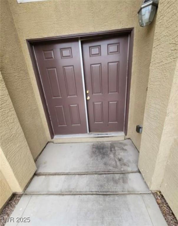 3237 Perching Bird Ln, North Las Vegas, NV 89084 - view of exterior entry featuring stucco siding
