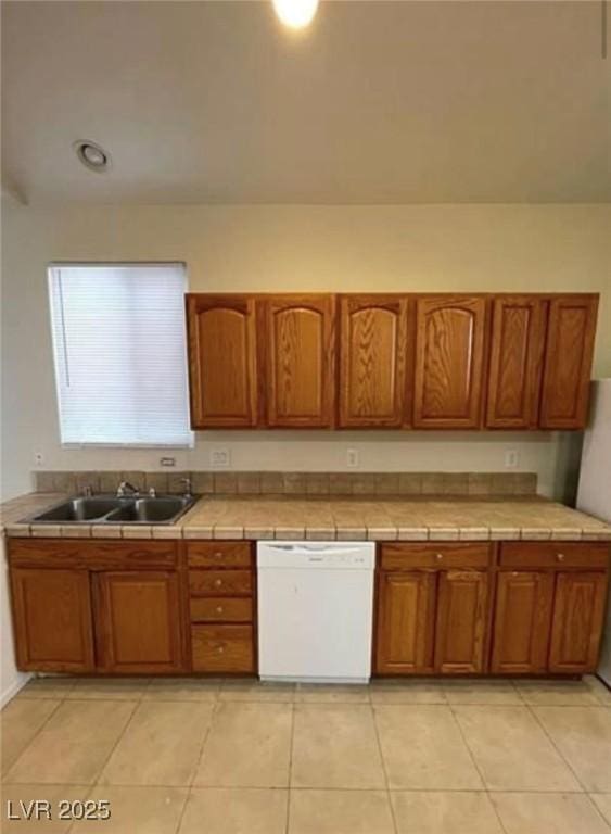 3237 Perching Bird Ln, North Las Vegas, NV 89084 - kitchen featuring dishwasher, tile countertops, brown cabinetry, and light tile patterned floors