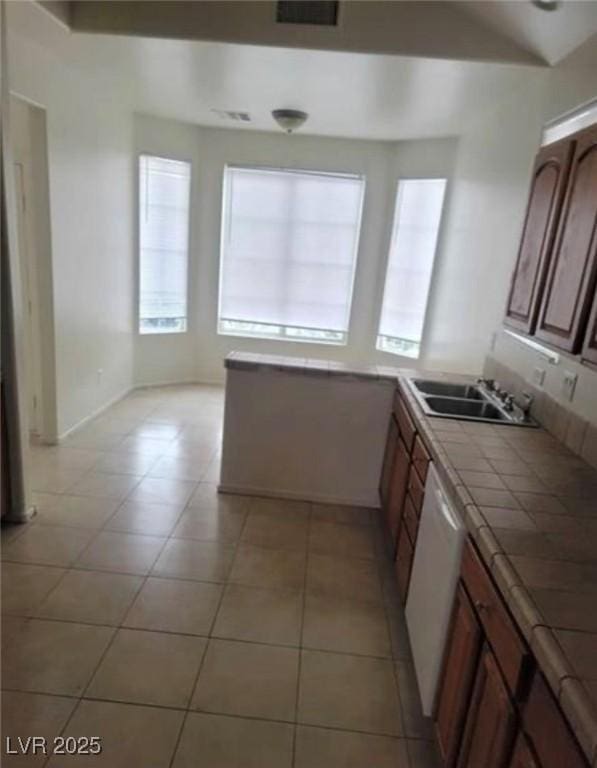 3237 Perching Bird Ln, North Las Vegas, NV 89084 - kitchen featuring tile countertops, dishwasher, and light tile patterned flooring