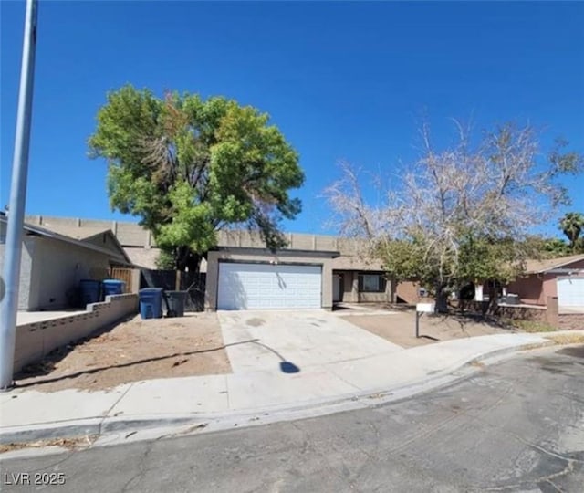 3755 Chutney St, Las Vegas, NV 89121 - view of front of house with a garage, concrete driveway, and stucco siding