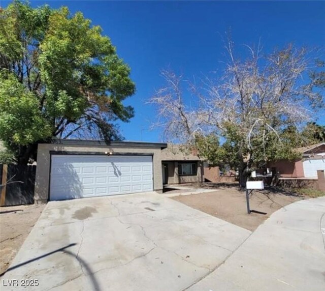 3755 Chutney St, Las Vegas, NV 89121 - view of front facade featuring stucco siding, concrete driveway, and a garage