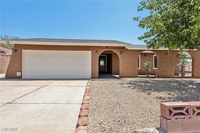 667 Del Prado Dr, Boulder City, NV 89005 - ranch-style home with stucco siding, concrete driveway, and an attached garage
