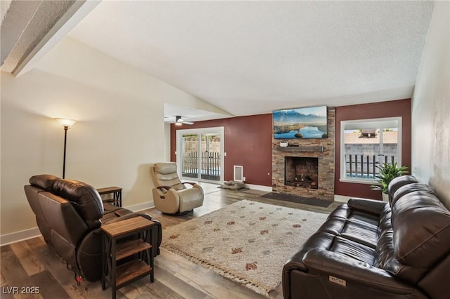667 Del Prado Dr, Boulder City, NV 89005 - living area featuring wood finished floors, a stone fireplace, and a ceiling fan