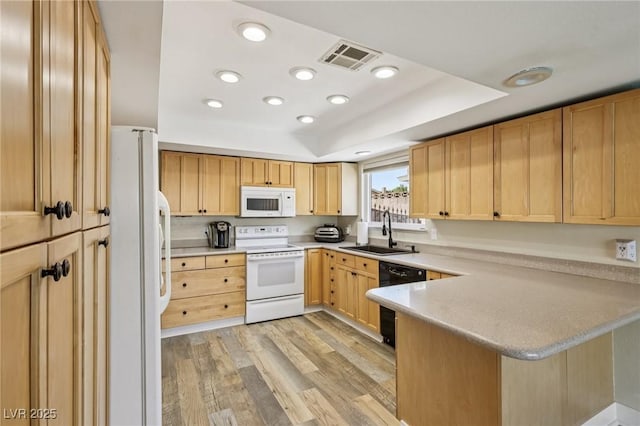 667 Del Prado Dr, Boulder City, NV 89005 - kitchen with white appliances, a peninsula, light wood finished floors, light countertops, and light brown cabinetry