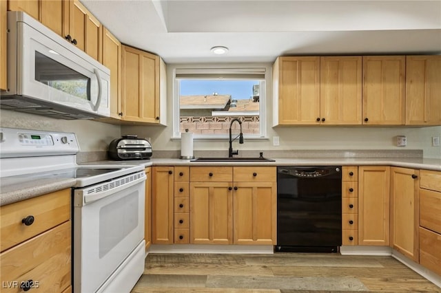 667 Del Prado Dr, Boulder City, NV 89005 - kitchen with white appliances, light brown cabinetry, light wood finished floors, and light countertops