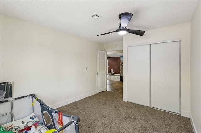 667 Del Prado Dr, Boulder City, NV 89005 - unfurnished bedroom featuring carpet floors, a ceiling fan, a textured ceiling, and a closet