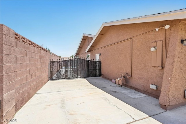 667 Del Prado Dr, Boulder City, NV 89005 - view of side of property featuring stucco siding and a gate
