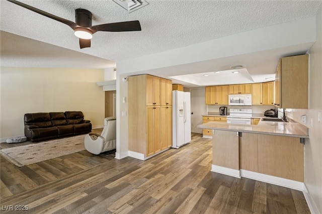 667 Del Prado Dr, Boulder City, NV 89005 - kitchen with white appliances, open floor plan, a peninsula, dark wood-style floors, and light brown cabinetry