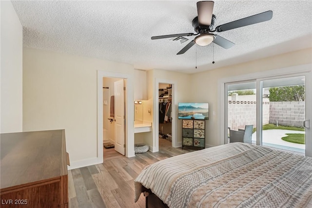 667 Del Prado Dr, Boulder City, NV 89005 - bedroom featuring a textured ceiling, a walk in closet, access to outside, wood finished floors, and a closet