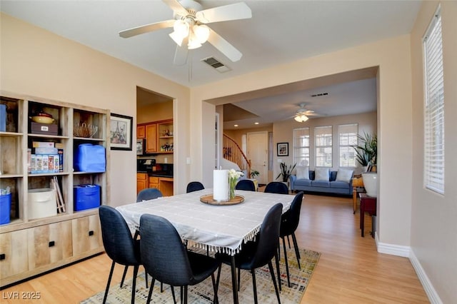 98 Milicity Rd, Henderson, NV 89012 - dining room featuring ceiling fan, stairs, and light wood-type flooring