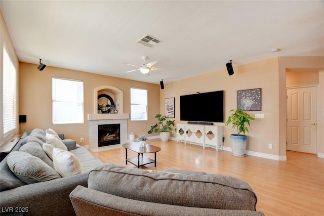 98 Milicity Rd, Henderson, NV 89012 - living area with wood finished floors, a ceiling fan, and a fireplace