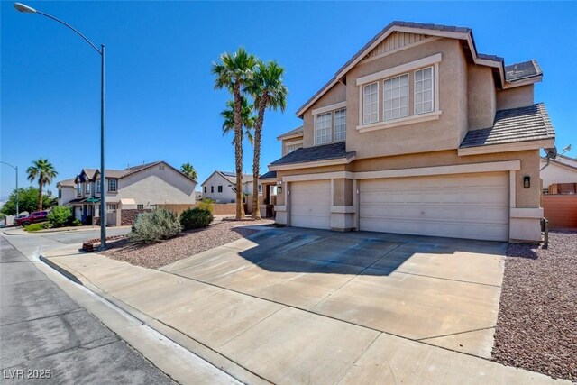 98 Milicity Rd, Henderson, NV 89012 - traditional-style home with a garage, stucco siding, driveway, and a residential view