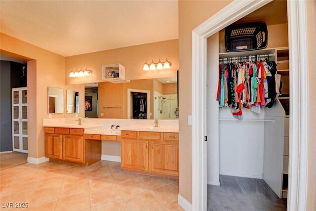 98 Milicity Rd, Henderson, NV 89012 - bathroom with double vanity, a walk in closet, a stall shower, and tile patterned flooring