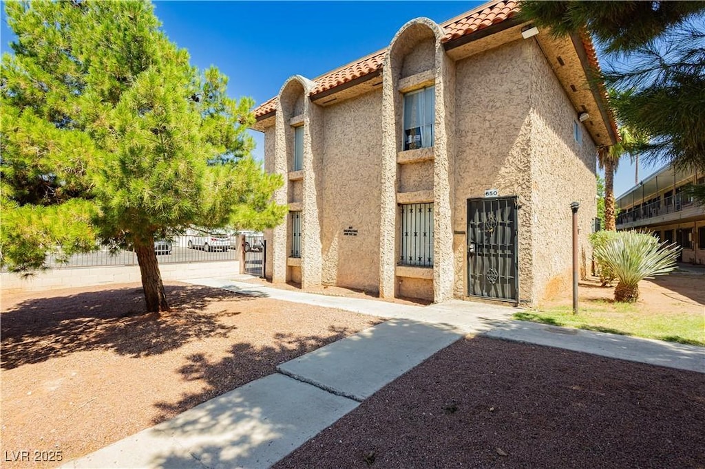 605 S Royal Crest Cir Unit 9, Las Vegas, NV 89169 - view of front facade with a tile roof and stucco siding