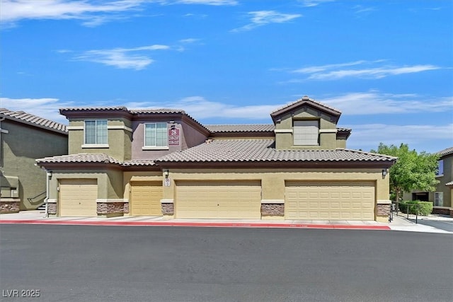 6868 Sky Pointe Dr Unit 1107, Las Vegas, NV 89131 - view of front of house with stone siding, stucco siding, and an attached garage