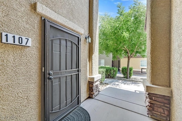 6868 Sky Pointe Dr Unit 1107, Las Vegas, NV 89131 - doorway to property featuring stucco siding