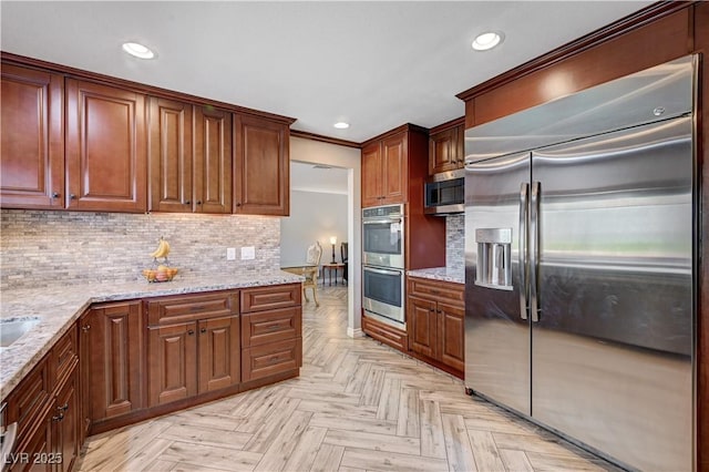 902 Dianne Dr, Boulder City, NV 89005 - kitchen with appliances with stainless steel finishes, recessed lighting, backsplash, light stone counters, and ornamental molding