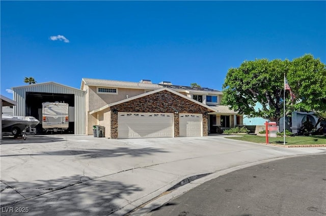 902 Dianne Dr, Boulder City, NV 89005 - view of front of house with a garage, driveway, stucco siding, and stone siding
