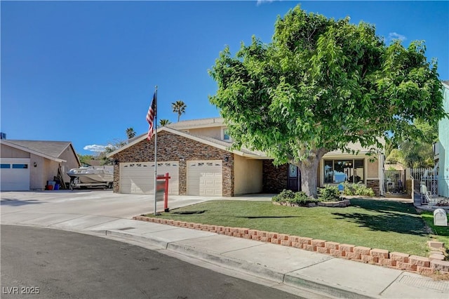 902 Dianne Dr, Boulder City, NV 89005 - view of front of property featuring stone siding, an attached garage, a front yard, driveway, and stucco siding