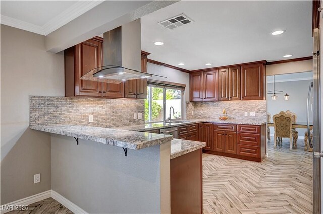 902 Dianne Dr, Boulder City, NV 89005 - kitchen with exhaust hood, ornamental molding, a peninsula, a breakfast bar area, and light stone counters