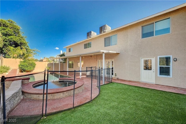 902 Dianne Dr, Boulder City, NV 89005 - rear view of house featuring stucco siding, a fenced backyard, an in-ground hot tub, and a patio