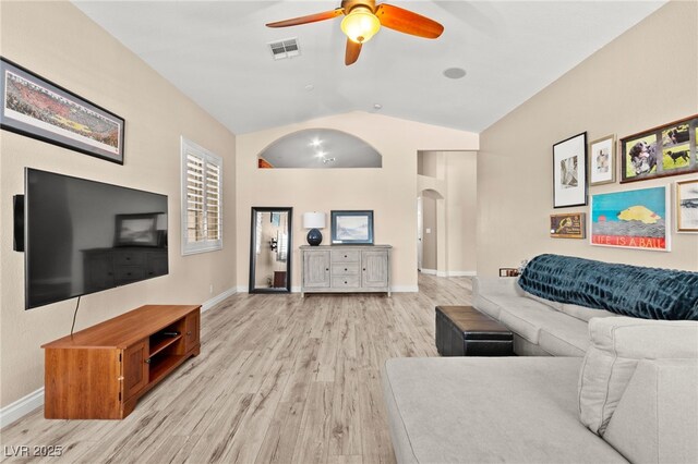 9733 Northern Dancer Dr, Las Vegas, NV 89117 - living room with arched walkways, a ceiling fan, light wood-type flooring, and high vaulted ceiling