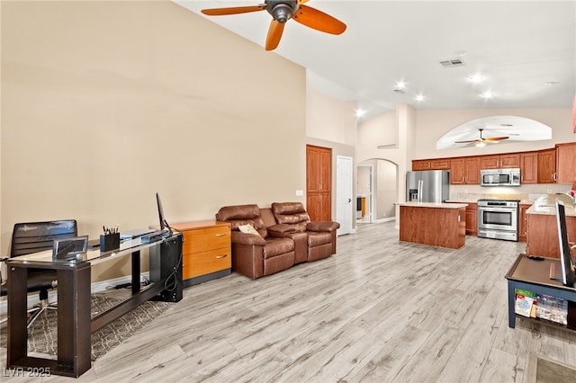 9733 Northern Dancer Dr, Las Vegas, NV 89117 - living area with a ceiling fan, arched walkways, high vaulted ceiling, light wood-style floors, and recessed lighting